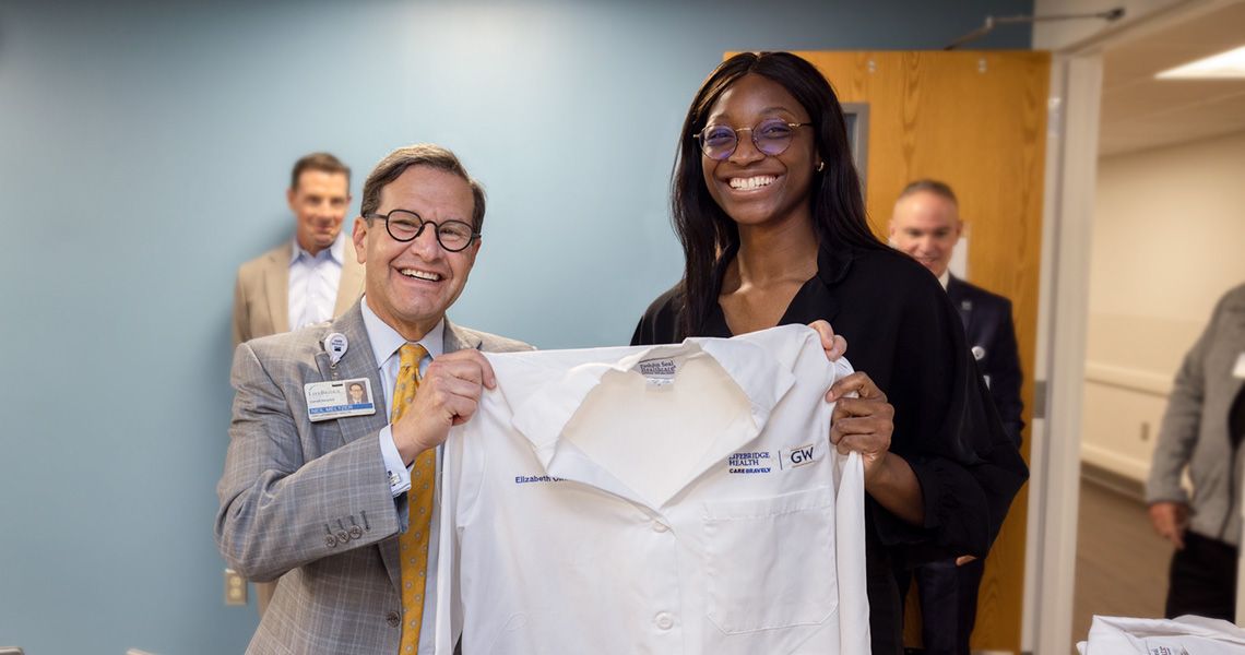 Student receiving her white coat